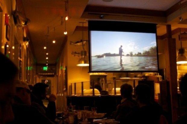 Anglers hang out at the Boatyard to enjoy fine fishing flicks. Photo by Gary Reich