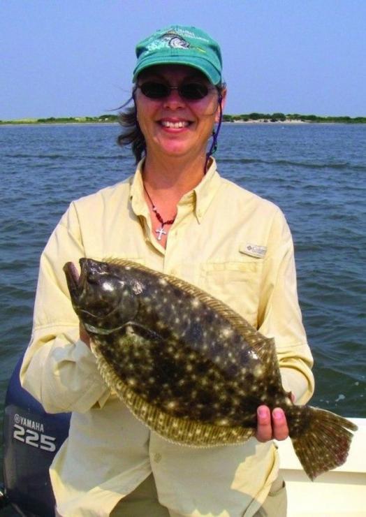 This happy angler caught a keeper flounder off Ocean City with Captain Lew. (Photo courtesy of Lew's Fly Angler)