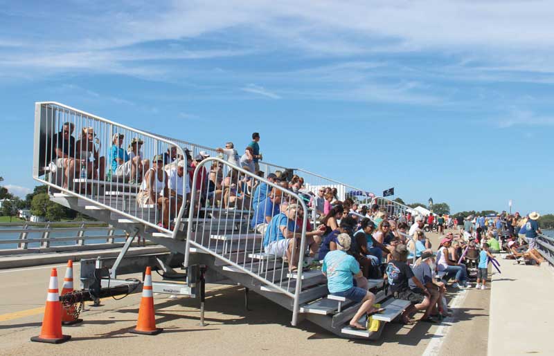 There is some bleacher seating available on the bridge, but best to bring a folding chair as an option.