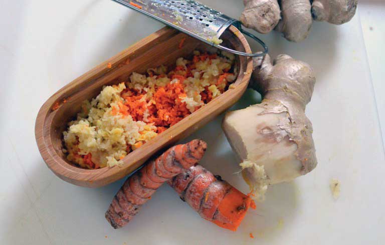 Grate the tumeric and ginger into a paste. Photos courtesy Caroline Foster