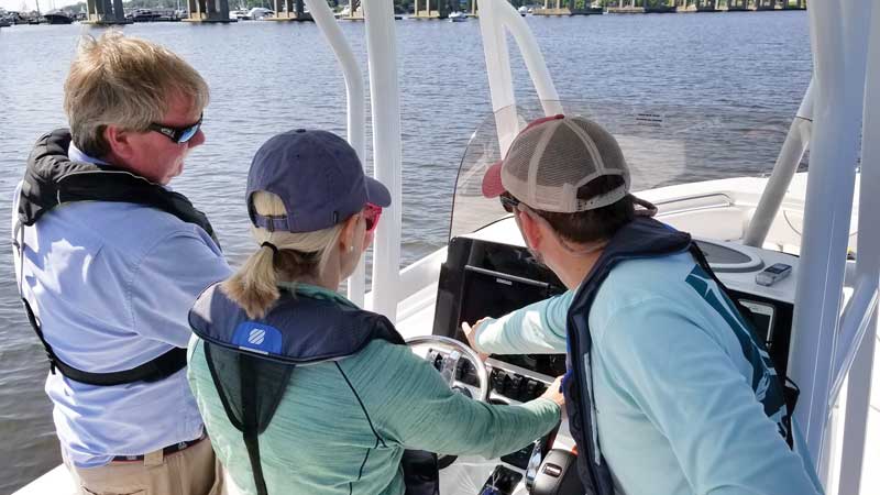 John Cosby of Annapolis Powerboat School helps Katie with navigation.