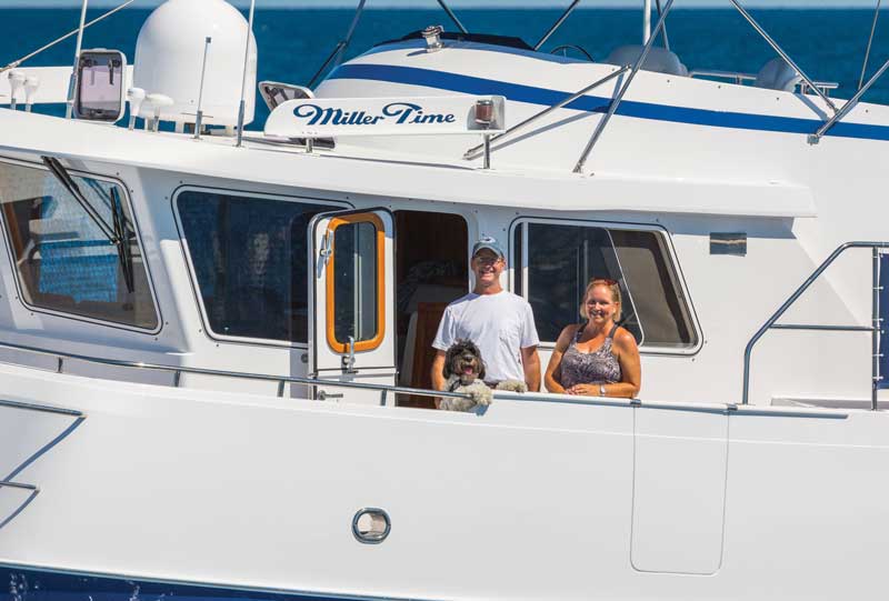 Scott, Teri, and Charlie in front of Miller Time's pilot house.