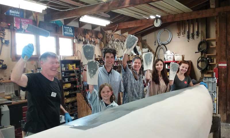 Tony Pettit, Patuxent Small Craft Guild volunteer, with visiting students from Bosnia in the shop at Solomons, MD.