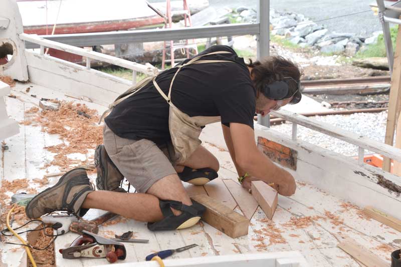 Shipwright Joe Connors caulks the deck on the bugeye Edna E Lockwood at the Chesapeake Bay Maritime Museum in St. Michaels, MD.