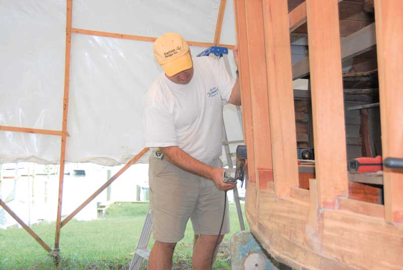 Jason Corsini fairing the ends of new stringers on a 1921 34-foot Chris Craft Commander at Marine Service in Edgewater, MD. Photo by Rick Franke