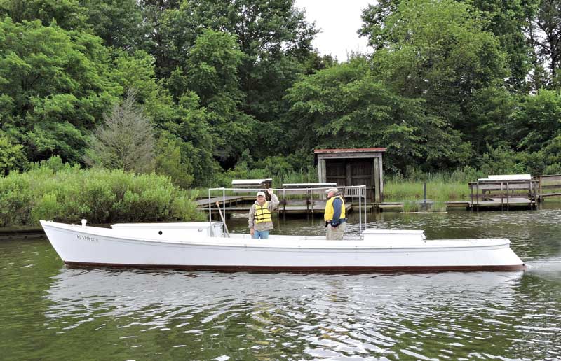 The Calvert Marine 1936 draketail departs for her annual haul out at Washburn’s Boat Yard in Solomons, MD. Shown here are shipwright George Surgent (L) and volunteer Ed Richard. 