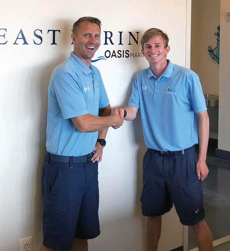 Andy Lancos and Edward Gary at Harbor East Marina, where he now works full time following MTAM's on-the-job training program. Photo courtesy of MTAM