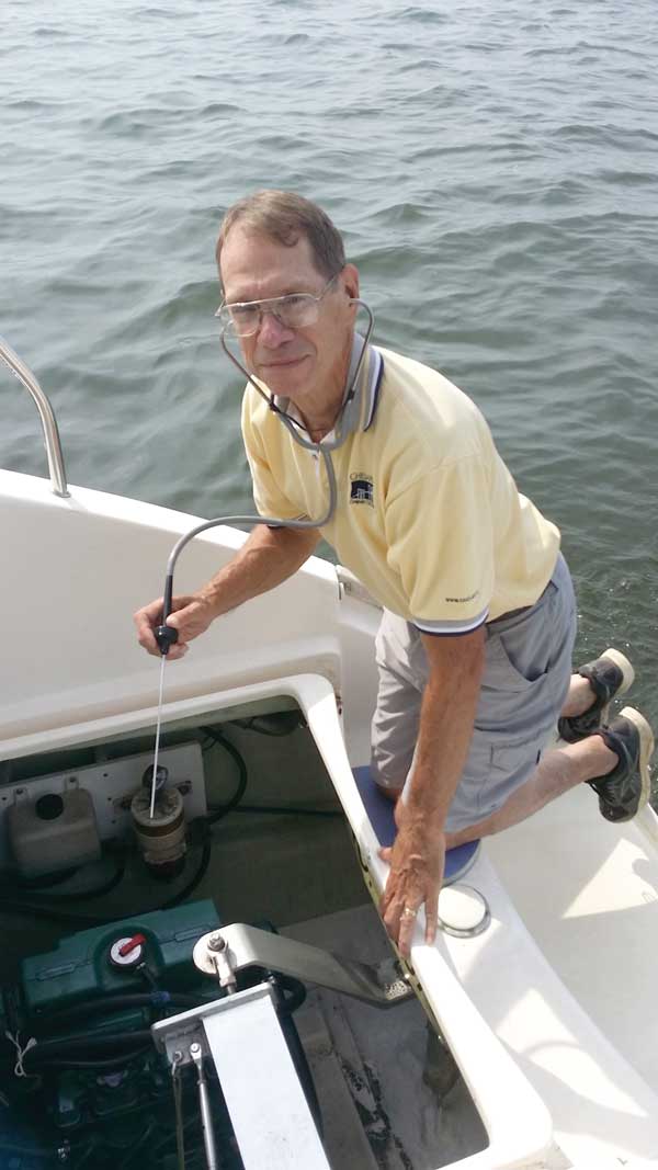 Terry Slattery uses a stethoscope to pinpoint concerning noises coming from his engine.