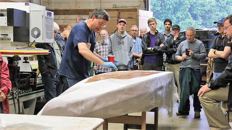 Visiting instructor Eric Schade of Shearwater Boats demonstrates the best way to apply fiberglass at Chesapeake Light Craft in Annapolis, MD.