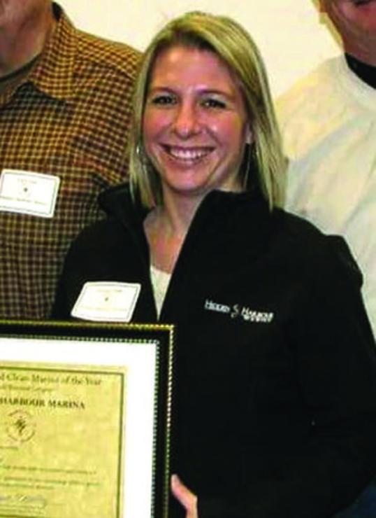Melissa Clark accepts Hidden Harbour Marina's Clean Marina of the Year award.