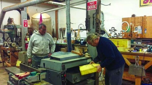 Peter Bell supervises the shaping of a block of Osage Orange for the buy boat Muriel Eileen in the shop at Hartge Yacht Yard in Galesville.