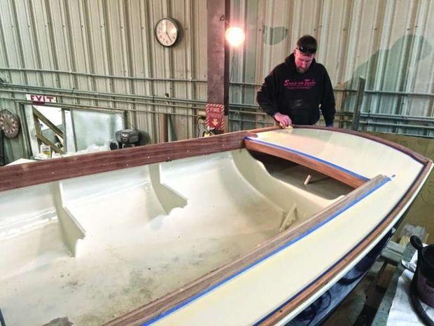 Eric Davis, master carpenter for Rappahannock Yachts in Irvington, VA, installs new teak cockpit comings and toe rails in a rare 1966 Naugus Typhoon.