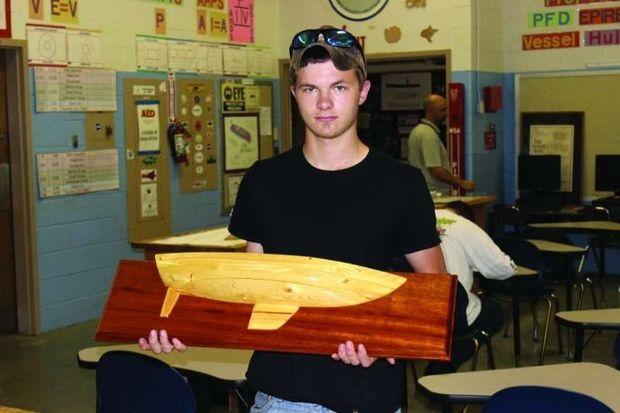 Austin Angermeir, a student at the Center for Applied Technology South in Edgewater, MD, displays a half model he built from plans this spring. Photo by Rick Franke