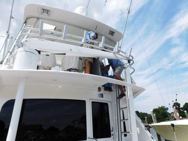 Workers at Blue Water Yacht Yard in Hampton, VA, put the finishing touches to an enlarged hatch on cuttin’ up, a Viking 52.