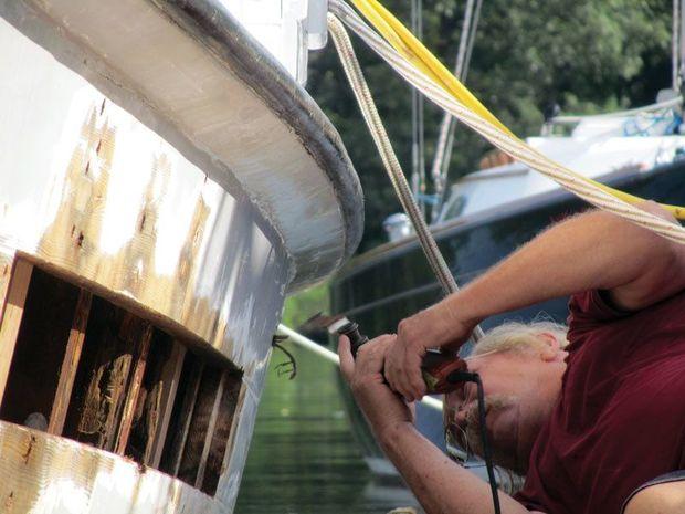 Ernie Stuermer working on the port plank and frames of a buyboat at Hartge Yacht Yard in Galesville, MD.