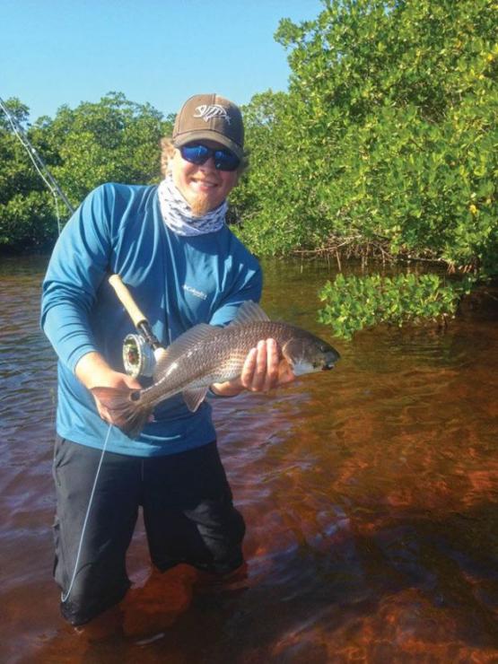 Matt Lee with a puppy drum caught on the fly. Photo courtesy of Matt Lee
