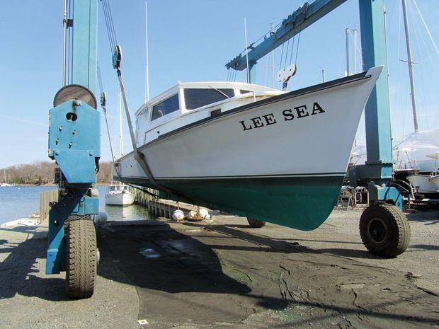 Lee Sea, a 1967 deadrise in the slings for bottom work and new running gear at Hartge Yacht Yard in Galesville, MD. Photo by Alex Schlegel