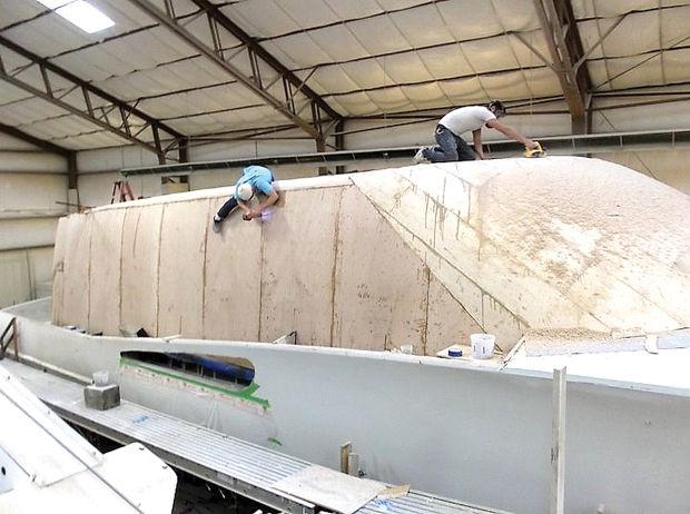 Workers at Weaver Boat Works in Deale, MD, assembling the cabin on a Weaver 80.