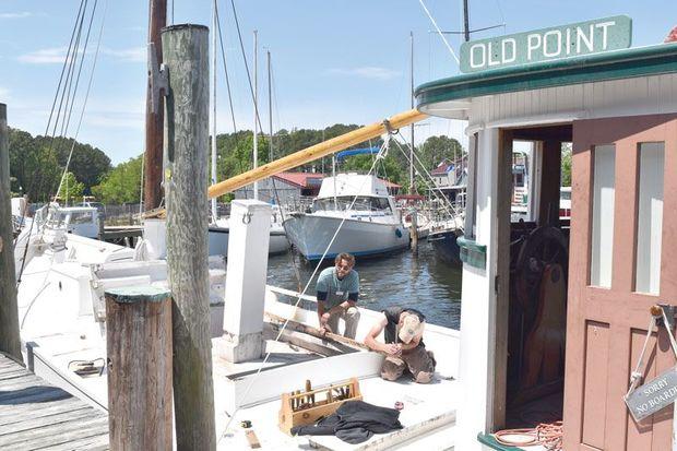 Shipwright James DelAguila and Apprentice Michael Allen work on the 1909 crab dredger Old Point at the Chesapeake Bay Maritime Museum in St. Michaels, MD.