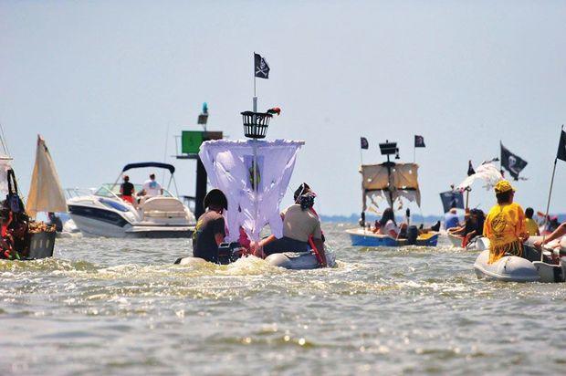 Dressed up dinghy pirates racing to the beach during the Pirates and Wenches Fantasy Weekend in Rock Hall August 11-14. Photo by Chessie Photo