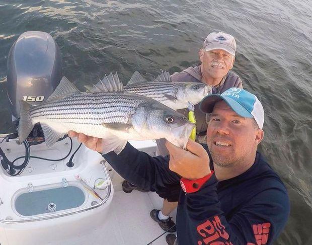 Travis Long (R) wearing the MOB+ while fishing with his father, Ed Long. Photo courtesy of Travis Long