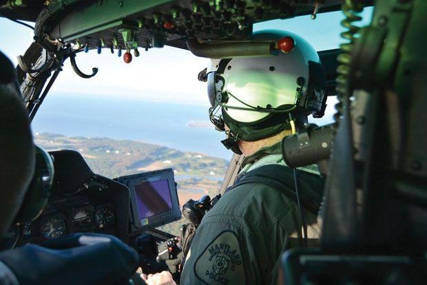 NRP pilot Sgt. John Buchanan at the controls of Natural 1 during an oyster patrol over the lower Eastern Shore. Photo courtesy of Maryland Natural Resources Police NRP pilot Sgt. John Buchanan at the controls of Natural 1 during an oyster patrol over the lower Eastern Shore. Photo courtesy of Maryland Natural Resources Police
