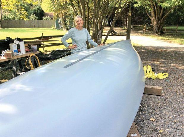 Eve Cook inspects her namesake, Eve, a nearly completed log canoe, in Hollywood, MD.