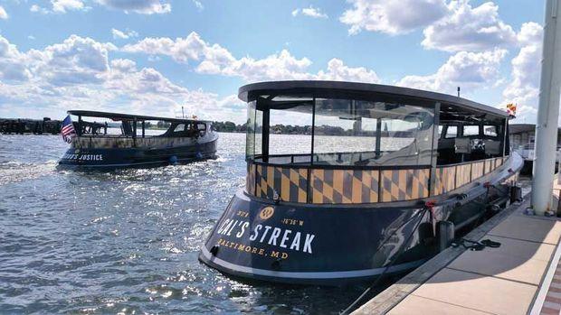 Two of the new draketail inspired Sagamore water taxis built at Maritime Applied Physics Corp in Baltimore, MD, at work on Baltimore Harbor.