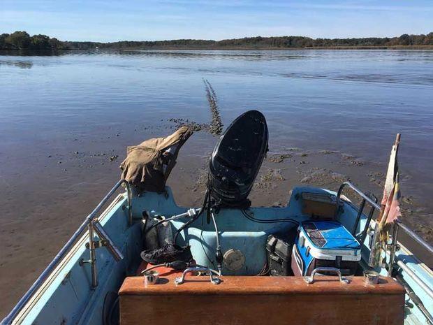 Thick mud held the Boston Whaler tight in its grasp.