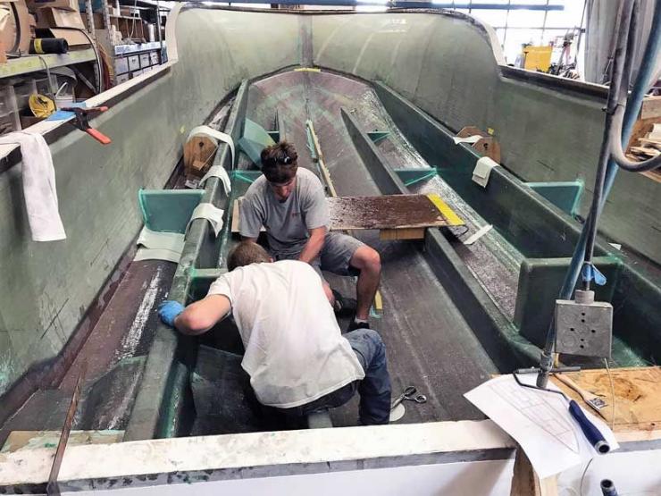 Leon Lukas and Nate Layman completing the stringers on the new CY 34 hull at Composite Yacht in Trappe, MD.