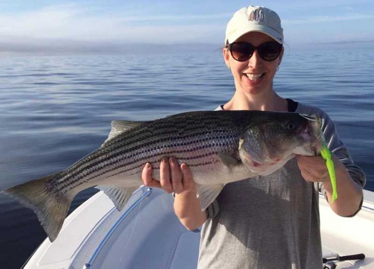 Nora Long shows off a nice keeper striper she caught in the Middle Bay. Photo courtesy Travis Long.