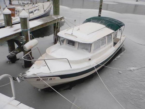 Snowed-over decks mean that the boat must take care of itself until a thaw.