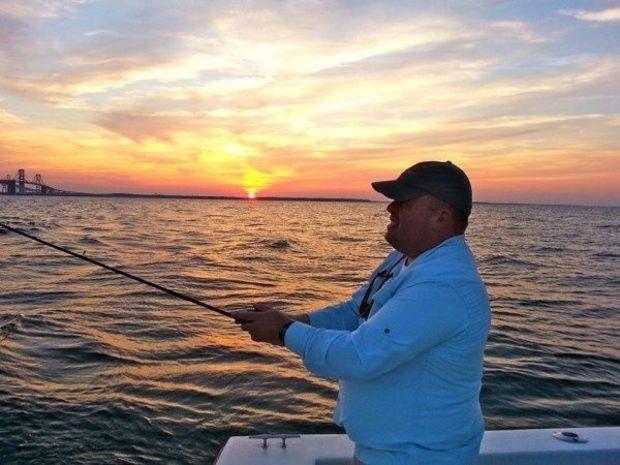 Gary Reich gives jigging a try with the help of Chesapeake Light Tackle author Shawn Kimbro. Photo by Shawn Kimbro