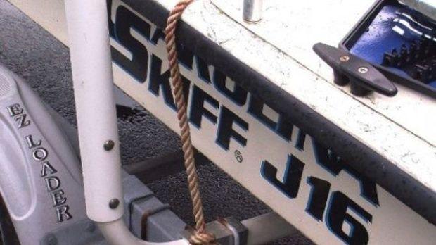 Image courtesy WBOC and shows the side of the 16-foot Carolina Skiff that a family of four clung to for five hours.