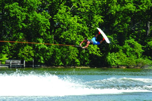 Fat Sac ballast bags in the stern of the Mastercraft X30 fill with water to create a huge wake that wakeboarder, Mike Stellabotte to get some serious air.