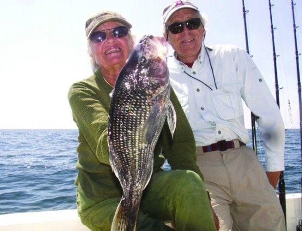 Martin Freed and Ruta Vaskys with a 4.5 lb. sea bass they caught 20 miles offshore.