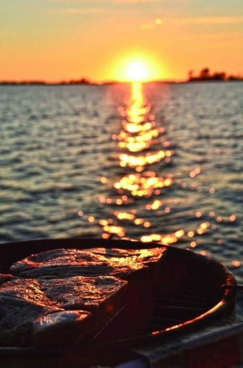 Grilling steaks at sunset. Photo by Michaela Urban Grilling steaks at sunset. Photo by Michaela Urban