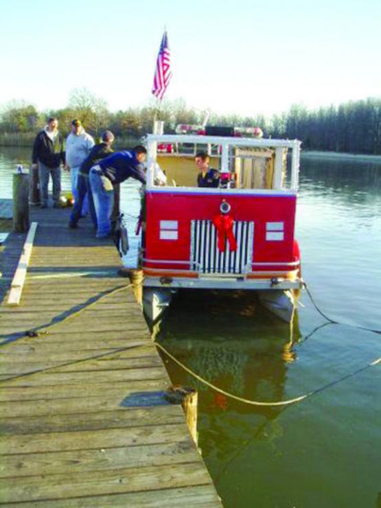 Building a fire truck on a pontoon boat. Crew: Nick, Zach, Doug, Jim, and Joanne Hock with Mr. Pat, and Joe and Greg Bosse. Building a fire truck on a pontoon boat. Crew: Nick, Zach, Doug, Jim, and Joanne Hock with Mr. Pat, and Joe and Greg Bosse.