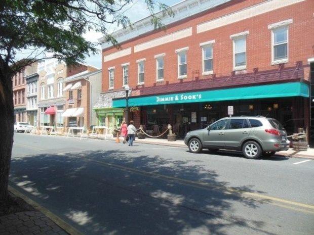 Restaurants and shops line Poplar Street in Cambridge.