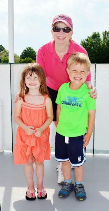 Capt. Judy Bixler poses with Samantha (3) and Nathan (4), students at St. Paul's Preschool in Trappe, who rode the ferry for a school outing.