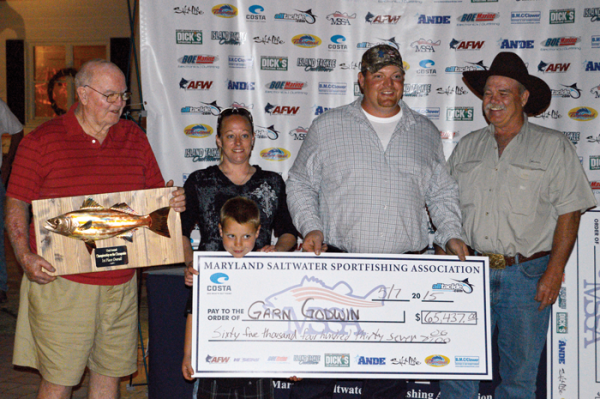 Garn Godwin recieves his big check at the MSSA awards party at Kurtz's beach.