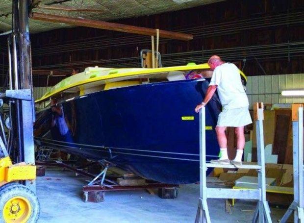 Designer Mike Price checking the hull to deck joint on an Eastport 32 at Mathews Brothers Boat Works in Denton, MD.
