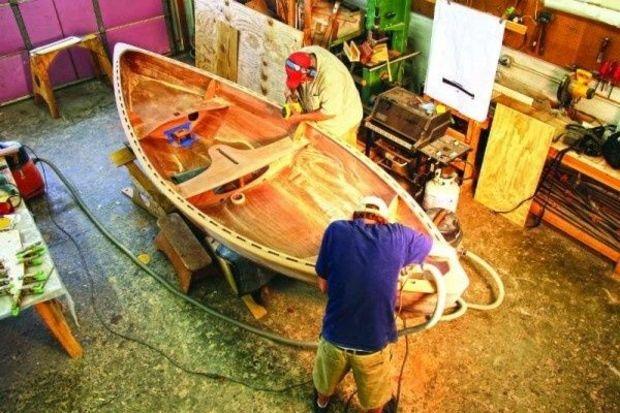 Workers assembling a double-ended skiff called a Skerry at Chesapeake Light Craft in Annapolis, MD.