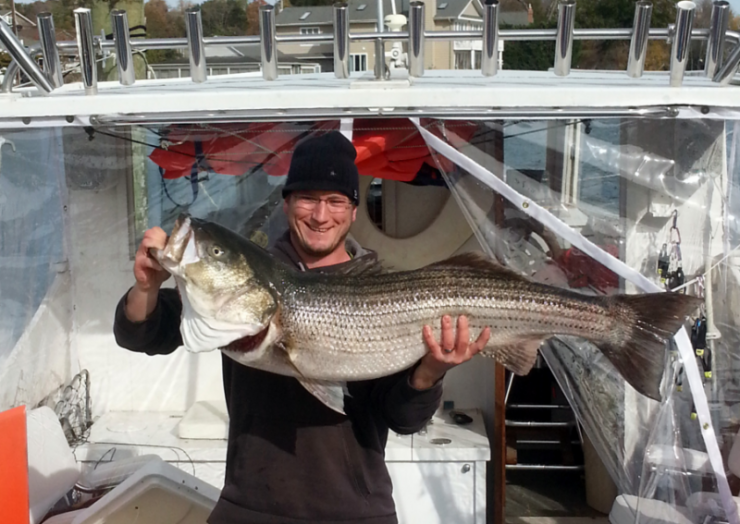 Michael Bussink holds up the 37-inch rockfish his team hauled in to win the 2014 Rocksgiving tournament.