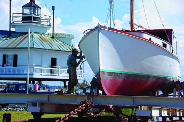 Shipwright apprentice Hans Wagner works on the 1926 trunk cabin cruiser Isabel at CBMM in St. Michaels, MD.