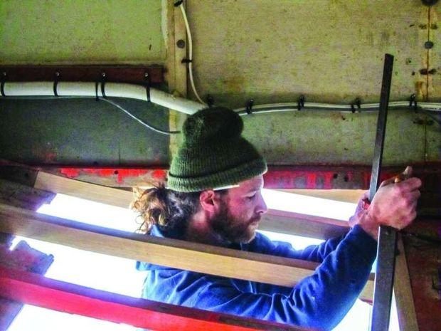 Carpenter Jack Samberg replacing bottom planks on a 1950s-era Trumpy motor yacht at Hartge Yacht Yard in Galesville, MD.