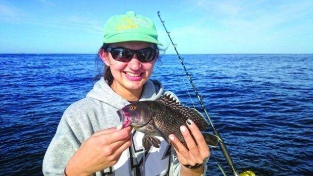 Georgia Tech student Haley Beebe caught her first fish, a sea bass. Photo courtesy Dr. Ken Neill, III