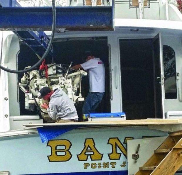 The crew at Bluewater Yacht Yards in Hampton, VA, removing an engine from a Viking 50.